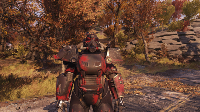 The character known as "BeAware" in the game "Fallout 76" is featured wearing a T-series power armor with a red and silver color scheme. The armor displays signs of wear and battle scars. The character is positioned on a road covered with fallen leaves, surrounded by an environment with trees showcasing autumn foliage, indicative of the game's detailed seasons and environments. The armor's helmet has round red eyes and a design that conveys a sense of strength and resilience. This setting is ch…