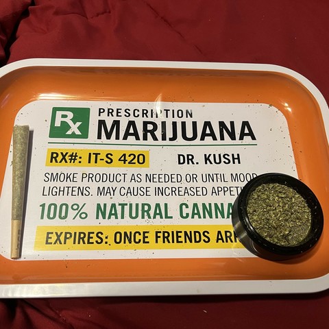 A picture of a rolling tray that says "Rx Prescription Marijuana RX#: IT-S 420

Dr. Kush

Smoke product as needed or until mood lightens. May cause increased appetite.

Expires: One Friends Arrive"

Sitting on the tray is a single weed joint and a grinder with some bud in it.